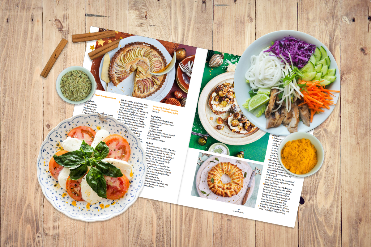 Flat lay of Inspire magazine recipes with an assortment of food and ingredients.